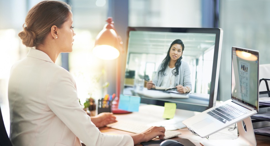 Female office worker sitting with the right ergonomic office set-up