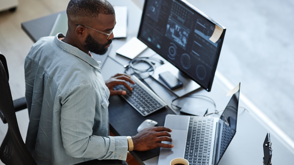 young man elevating his workspace with the essential ergonomic desk accessories