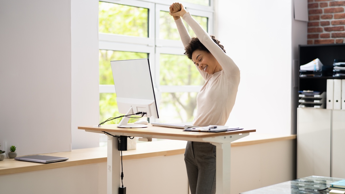 woman adopting a healthier ergonomic workspace