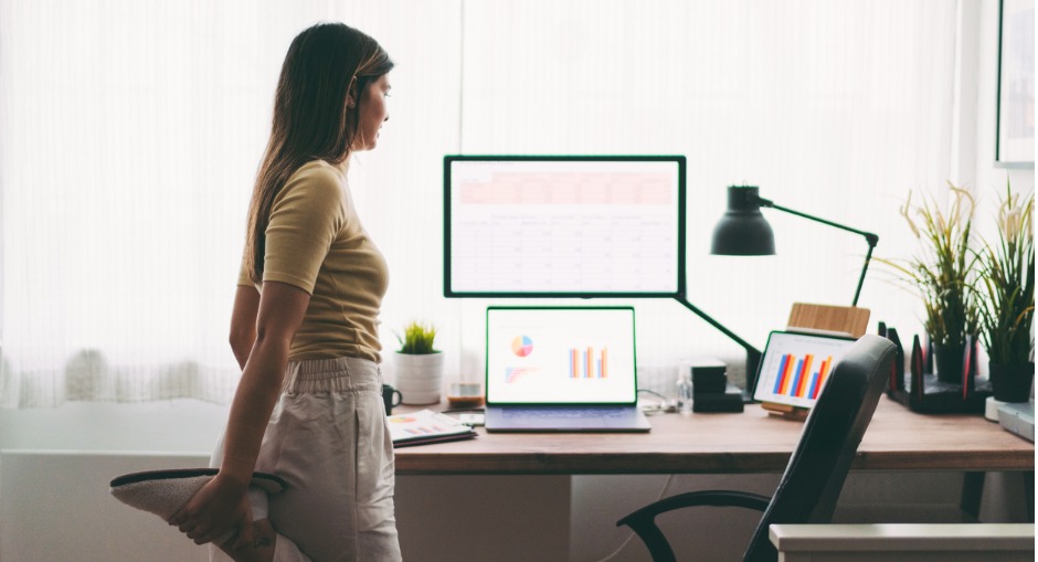 Woman doing ergonomic exercises while working from her desk at home.