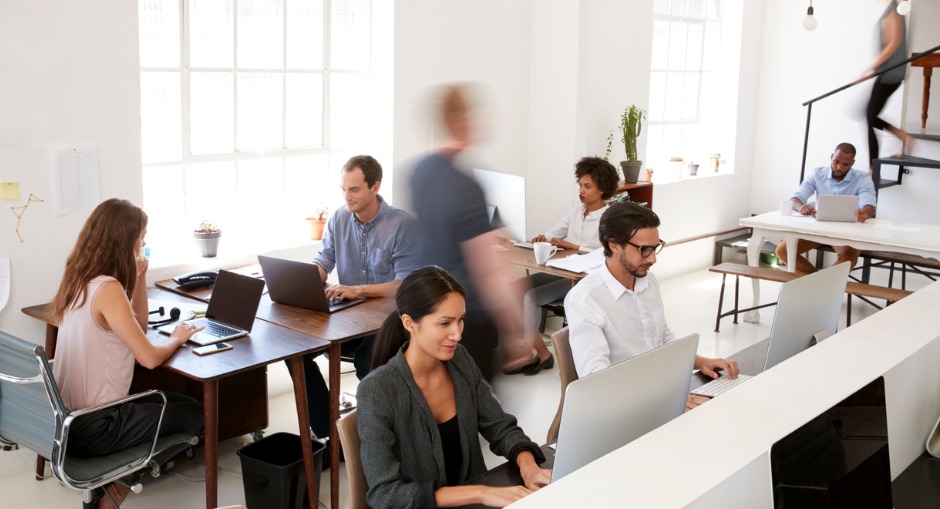 Open-plan modern office with busy employees 