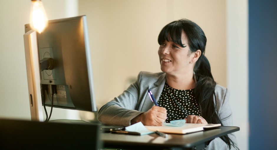 Female office-worker enjoying her portable standing desk 