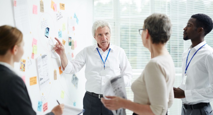 Coworkers discussing safety culture in the workplace during an afternoon meeting.